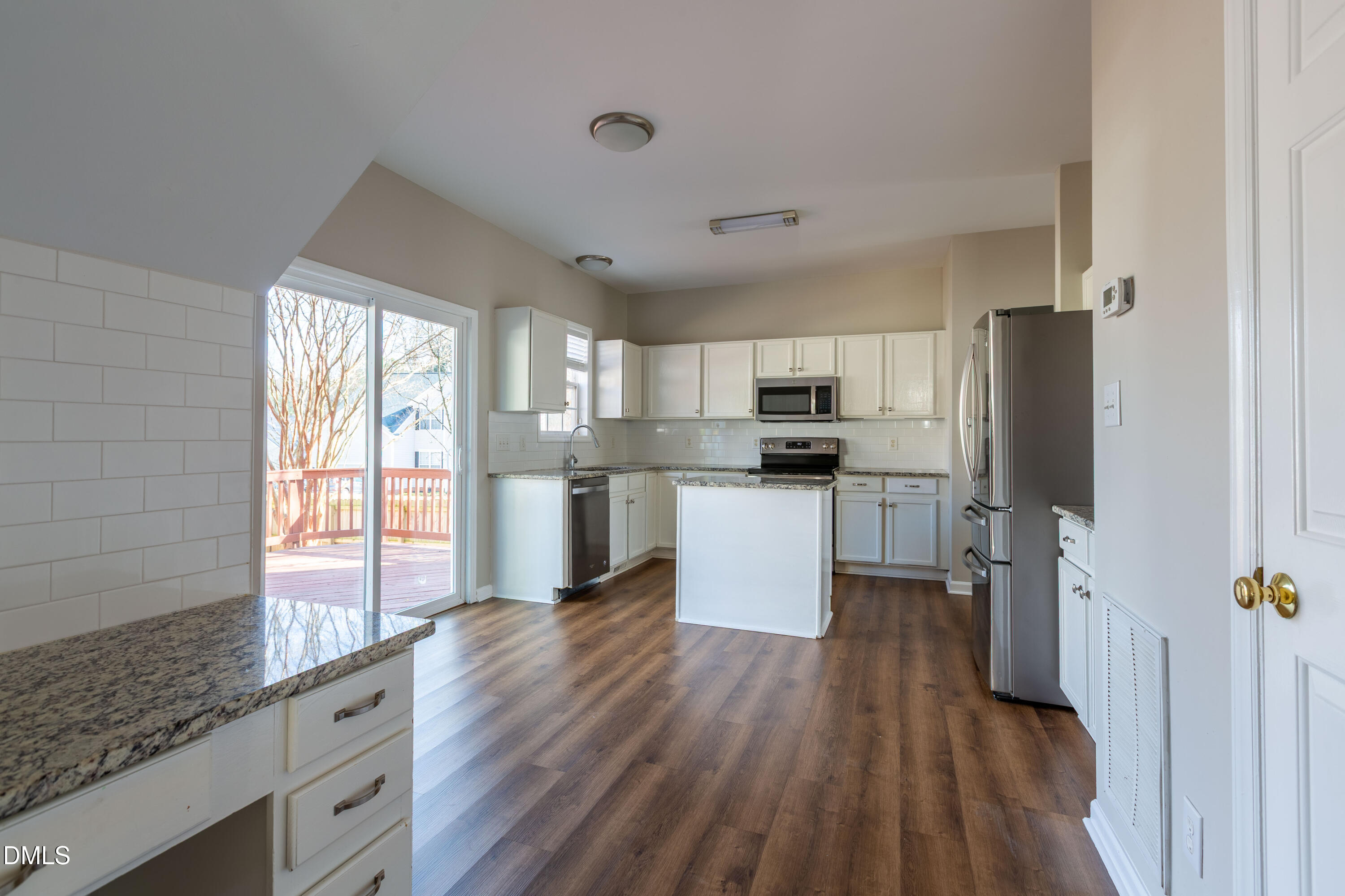 2339 School Creek Place Raleigh, NC 27606 - Photo 13 of 59 a kitchen with stainless steel appliances granite countertop a refrigerator a sink dishwasher a stove and white countertops with wooden floor