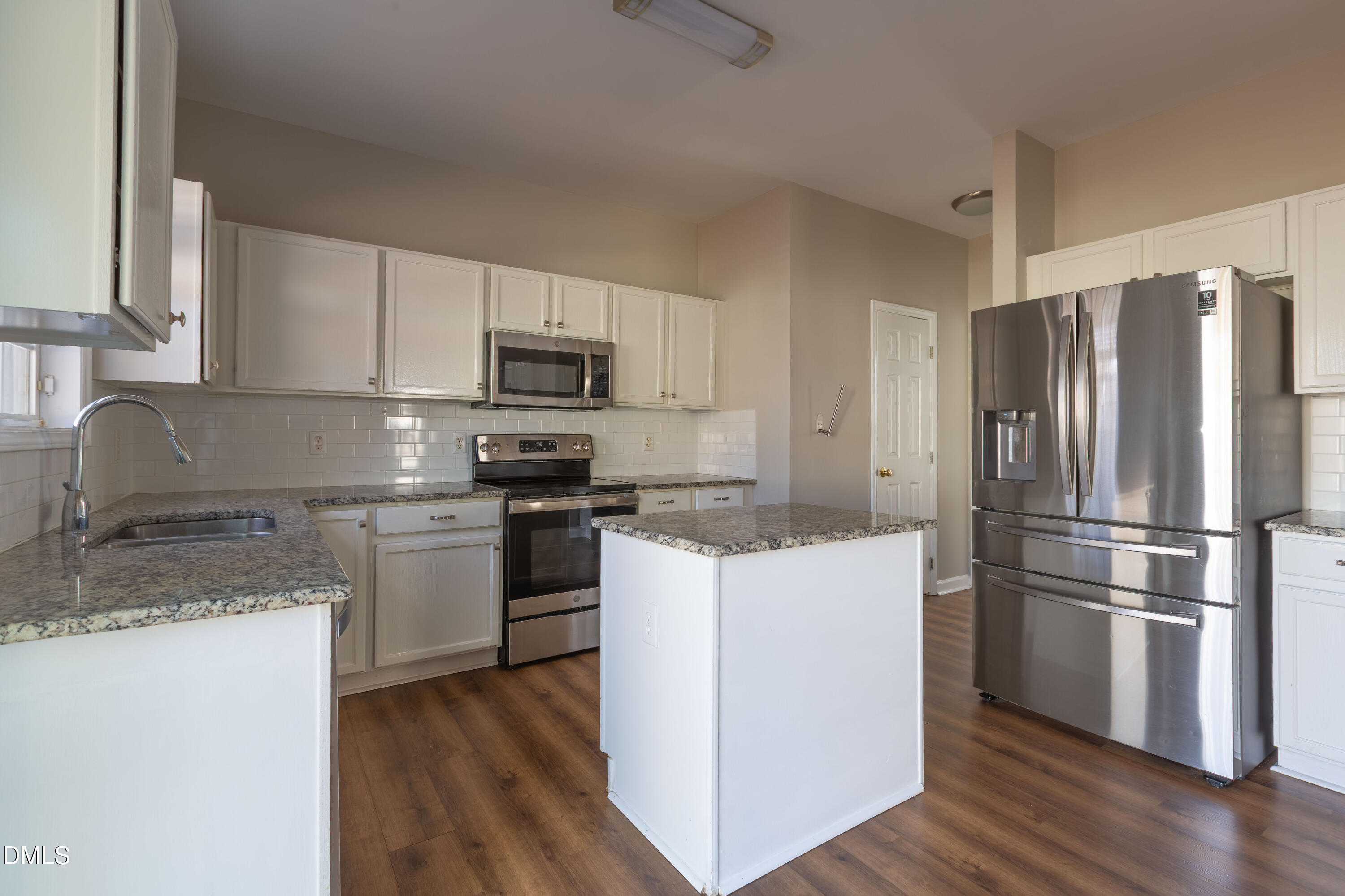2339 School Creek Place Raleigh, NC 27606 - Photo 14 of 59 a kitchen with a refrigerator stove and wooden cabinets