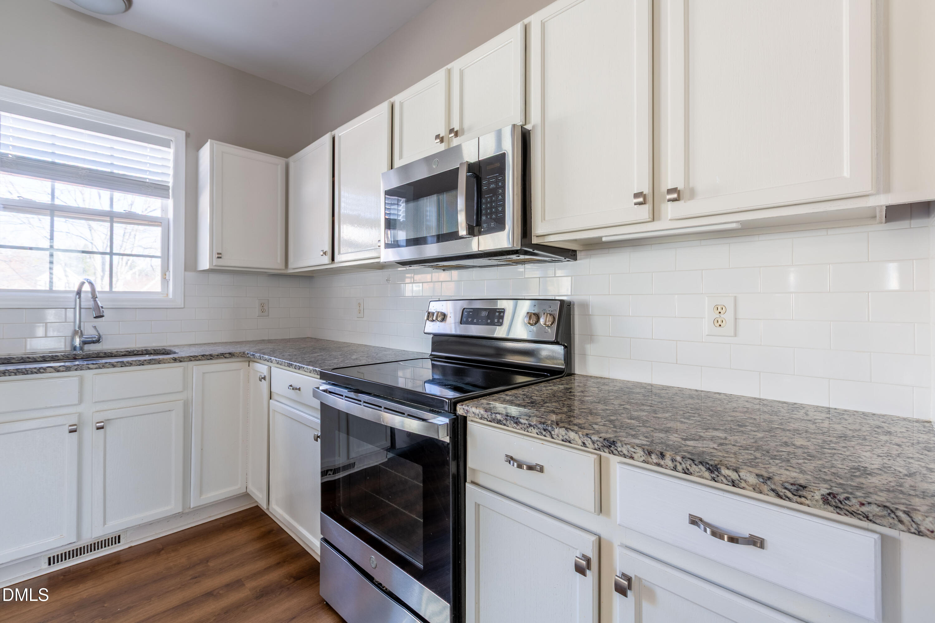 2339 School Creek Place Raleigh, NC 27606 - Photo 17 of 59 a kitchen with stainless steel appliances granite countertop a sink and a stove