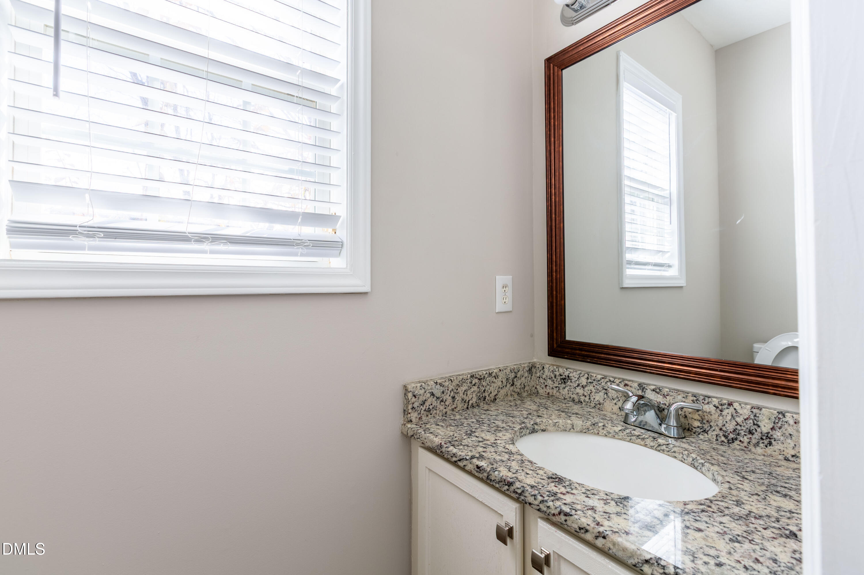 2339 School Creek Place Raleigh, NC 27606 - Photo 19 of 59 a bathroom with a granite countertop sink and a mirror