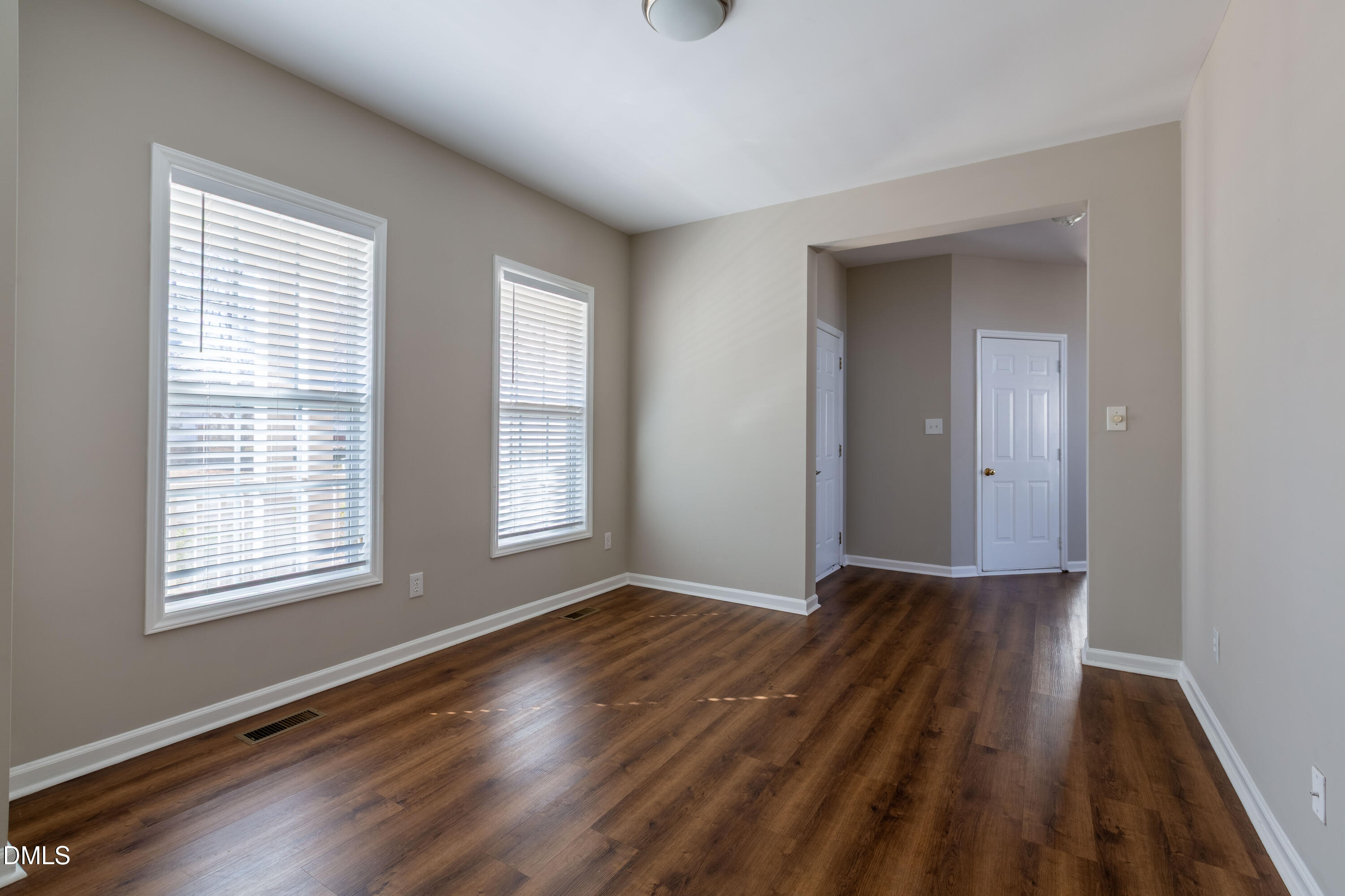 2339 School Creek Place Raleigh, NC 27606 - Photo 21 of 59 a view of an empty room with wooden floor and a window