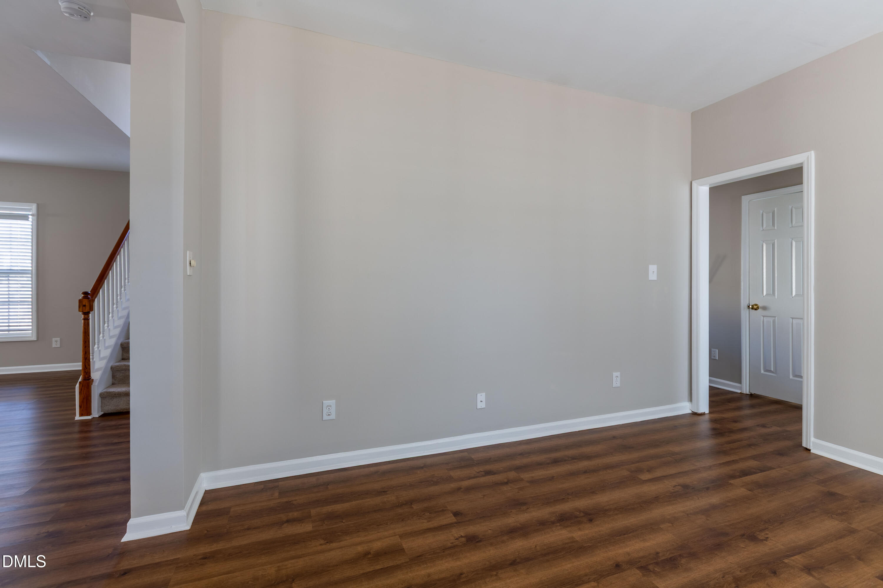 2339 School Creek Place Raleigh, NC 27606 - Photo 22 of 59 a view of an empty room with wooden floor and stairs