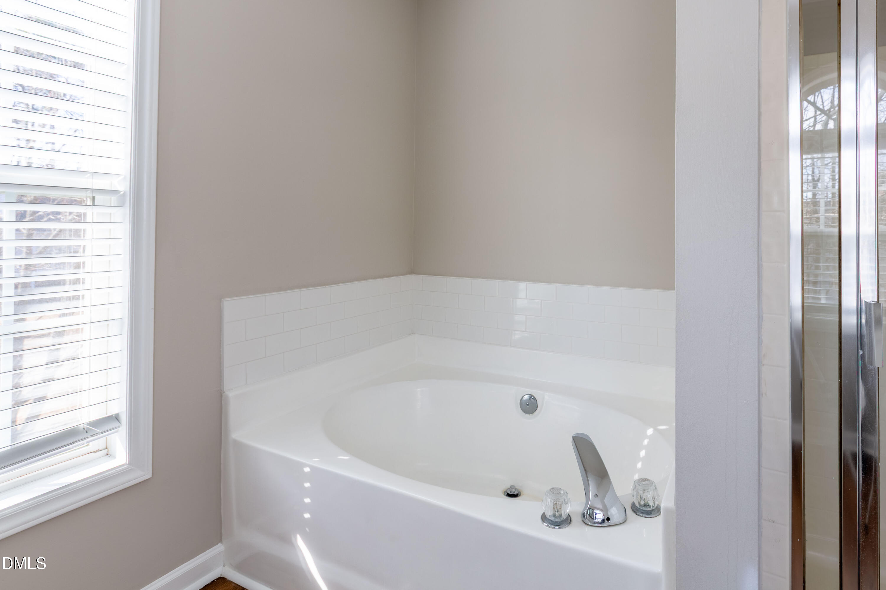 2339 School Creek Place Raleigh, NC 27606 - Photo 27 of 59 a white bath tub sitting in a bathroom