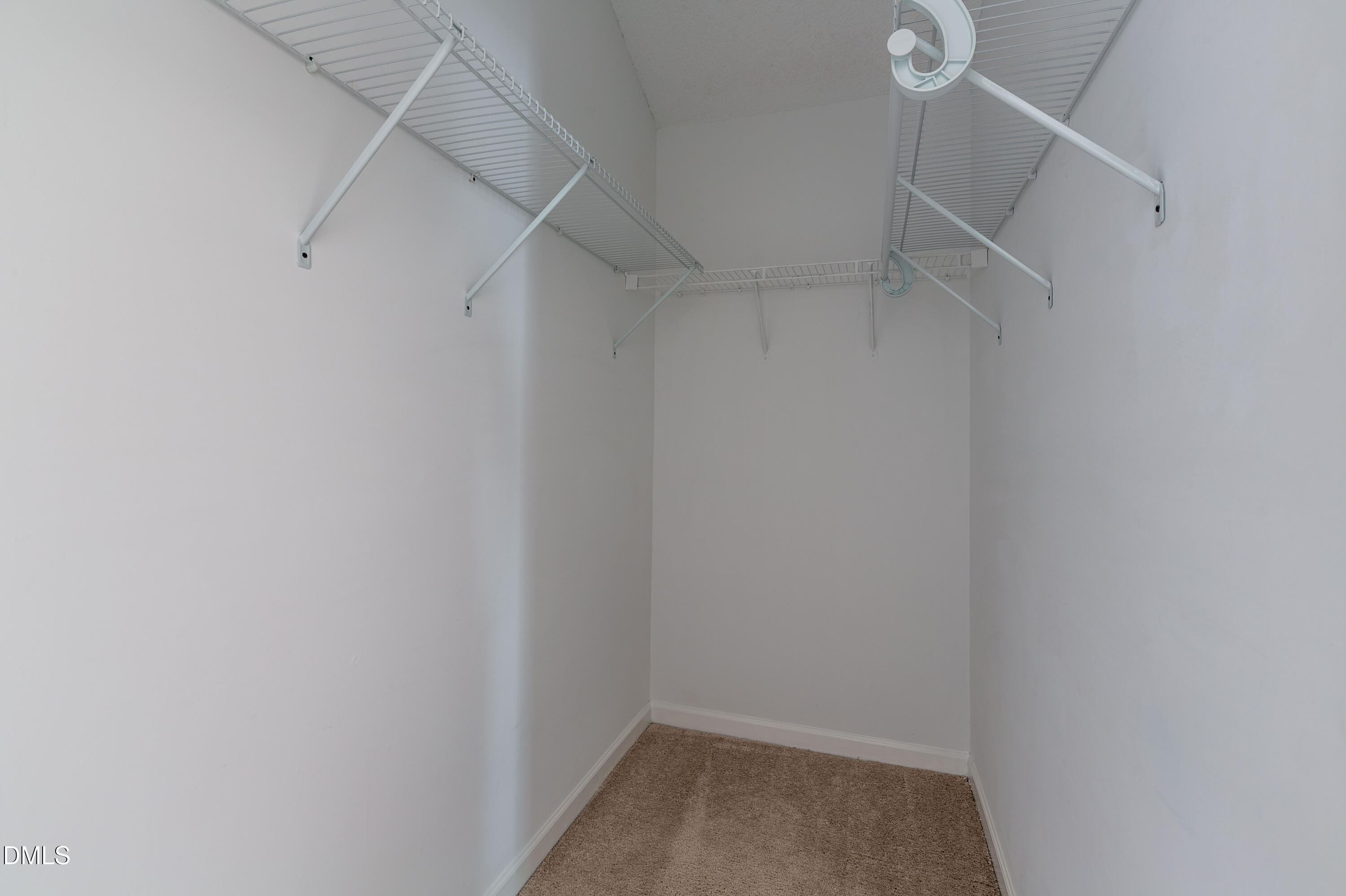 2339 School Creek Place Raleigh, NC 27606 - Photo 29 of 59 a view of walk in closet with empty racks