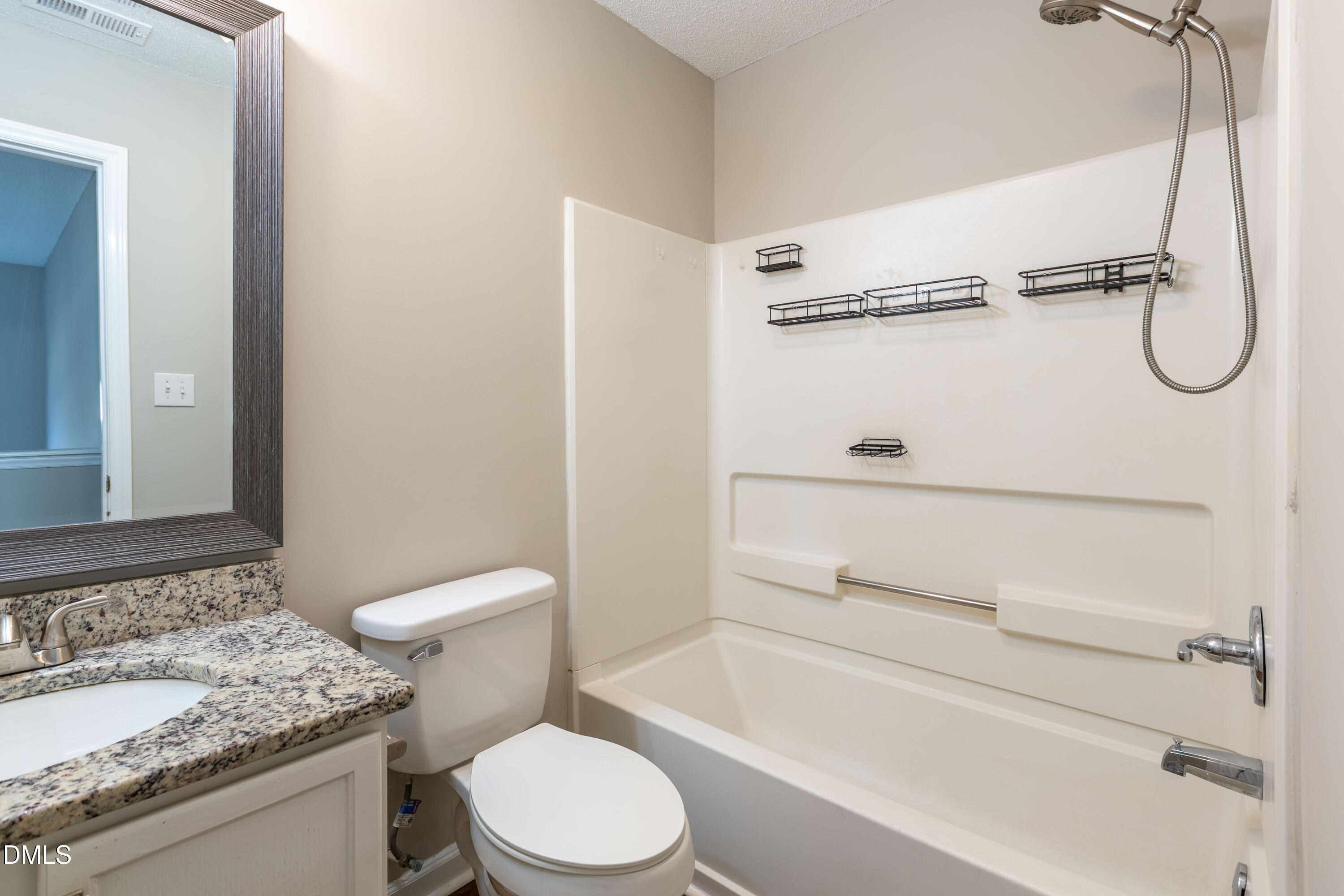 2339 School Creek Place Raleigh, NC 27606 - Photo 32 of 59 a bathroom with a granite countertop toilet sink and a mirror