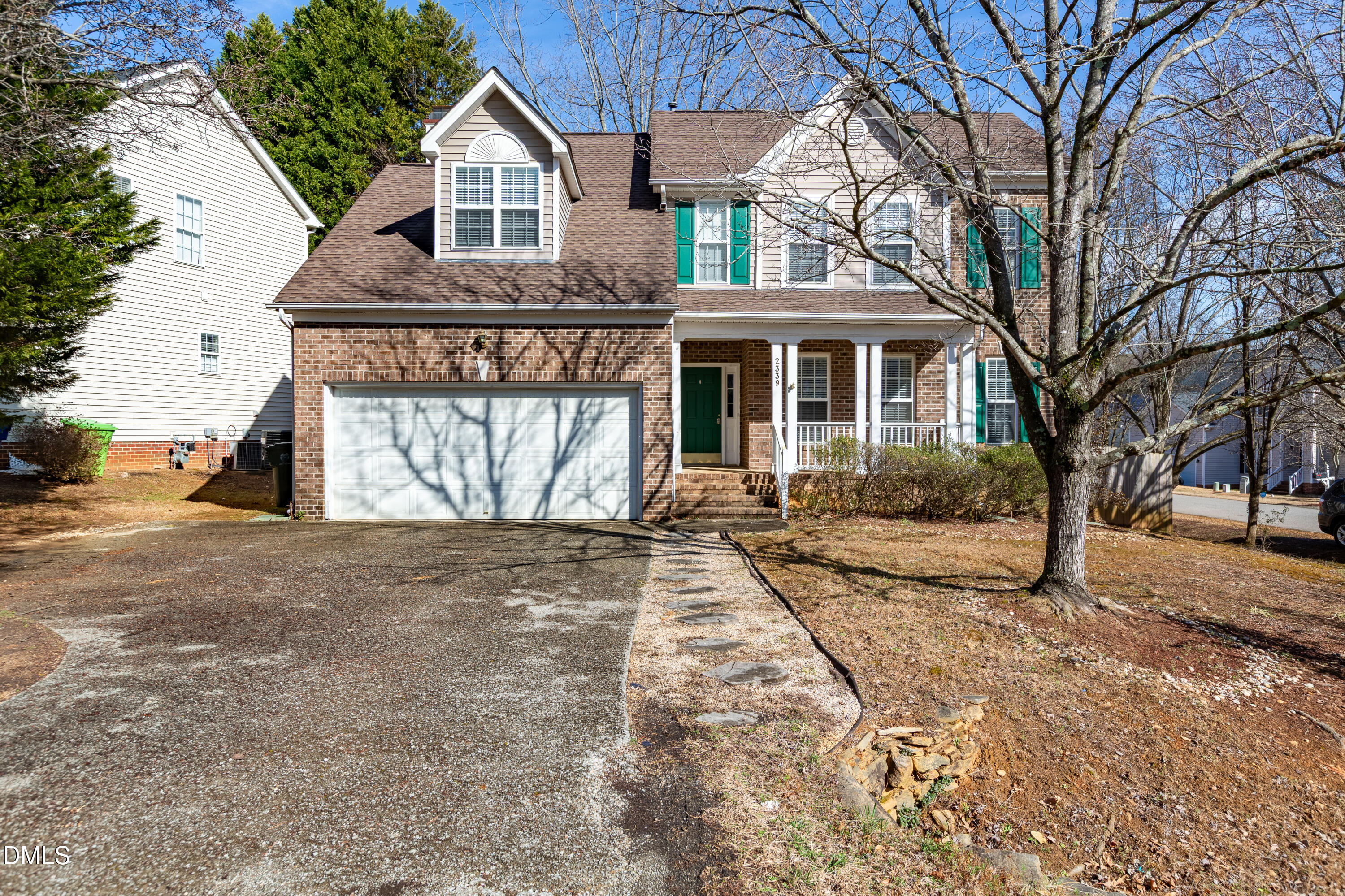 2339 School Creek Place Raleigh, NC 27606 - Photo 4 of 59 a front view of a house with a yard and garage