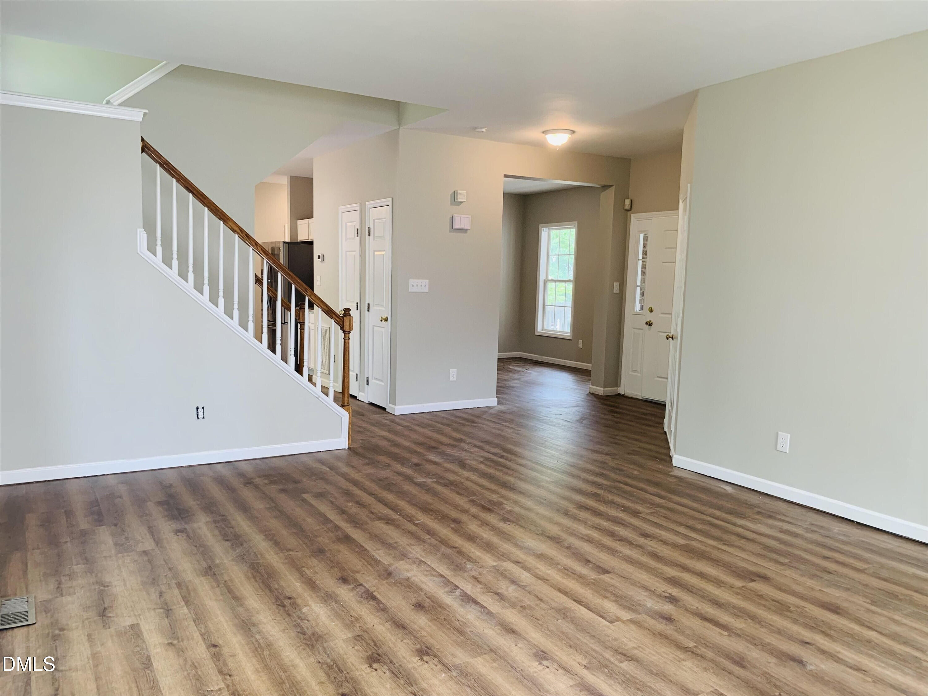 2339 School Creek Place Raleigh, NC 27606 - Photo 4 of 11 a view of a hallway view with wooden floor and staircase