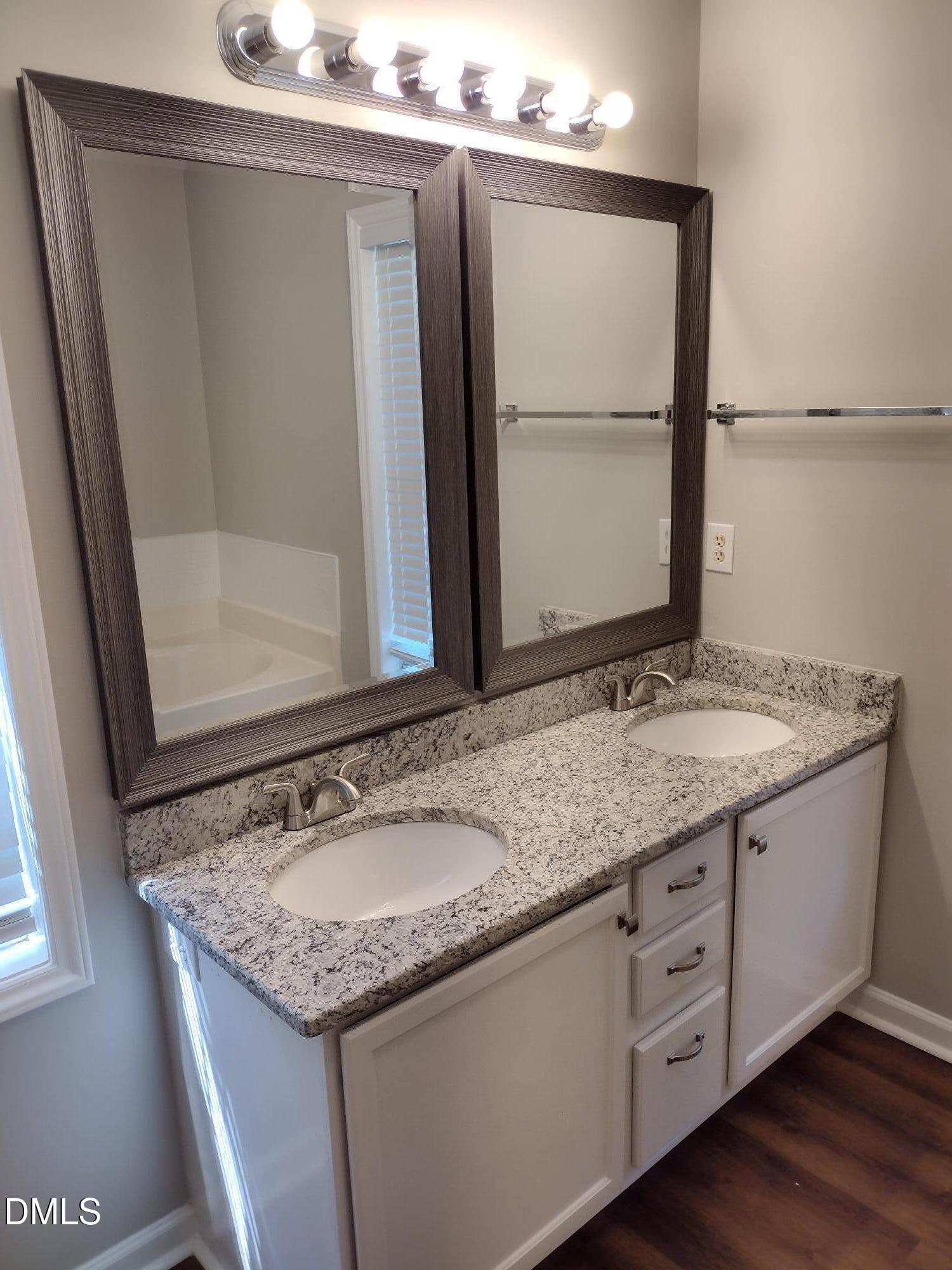 2339 School Creek Place Raleigh, NC 27606 - Photo 9 of 11 a bathroom with a granite countertop sink and mirror