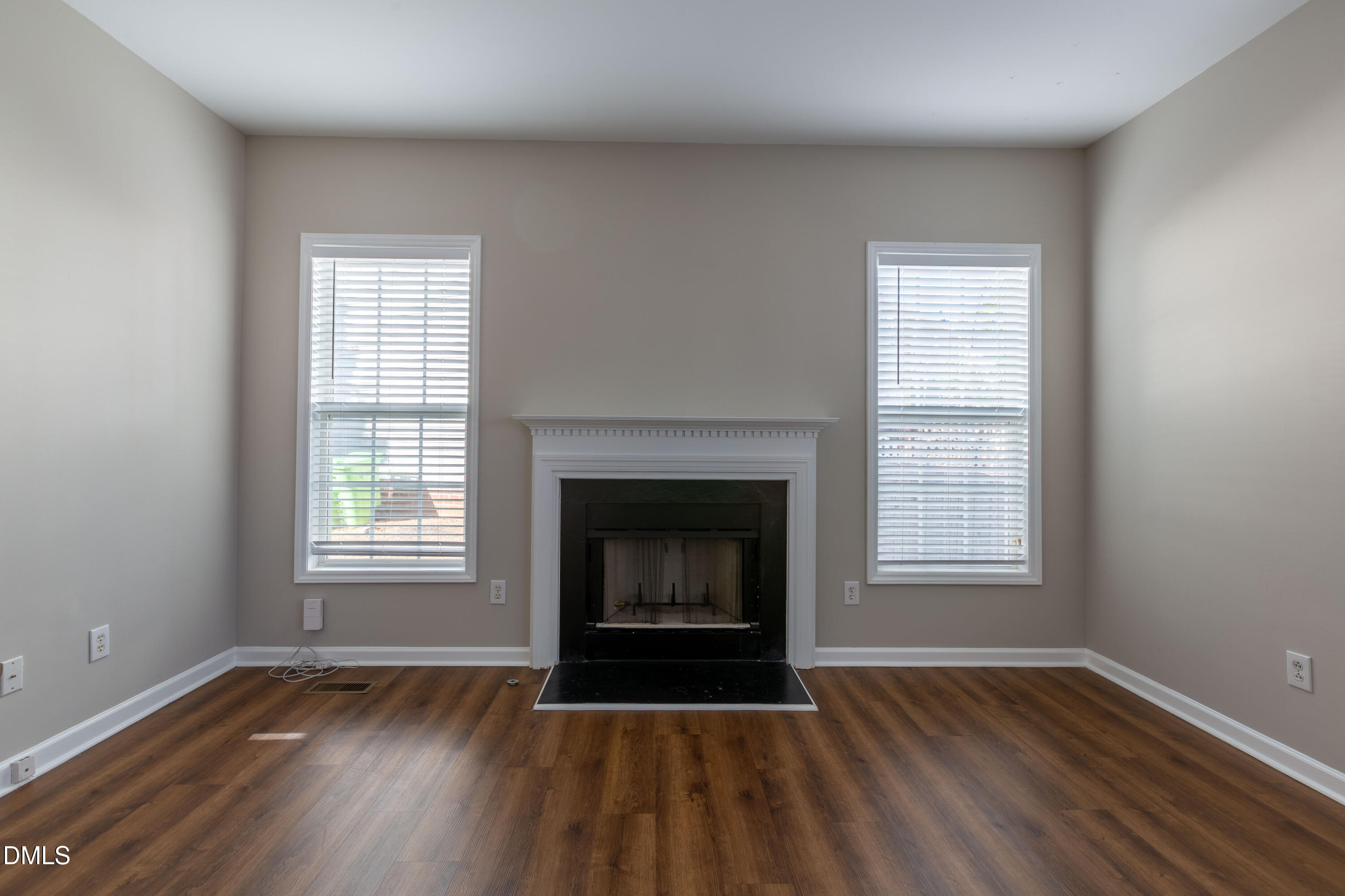 2339 School Creek Place Raleigh, NC 27606 - Photo 10 of 59 an empty room with wooden floor fireplace and window