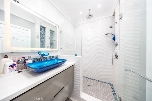 a bathroom with a tub sink and mirror