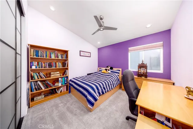 a bedroom with furniture and a book shelf