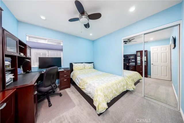 a bedroom with a bed and a television