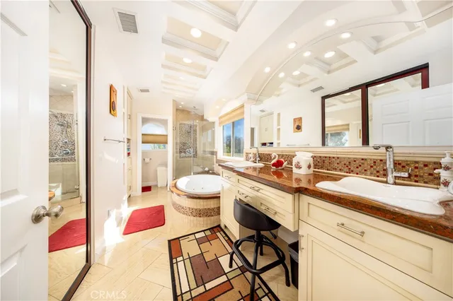 a large white kitchen with a stove a sink and dishwasher