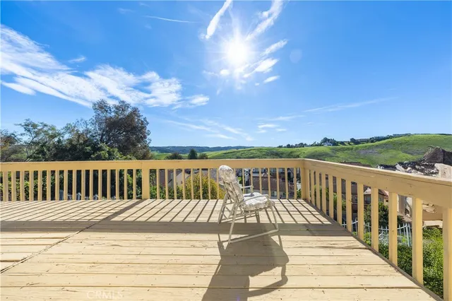 a view of balcony with wooden floor and city view