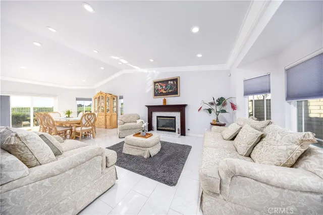 a living room with furniture fireplace and a large window