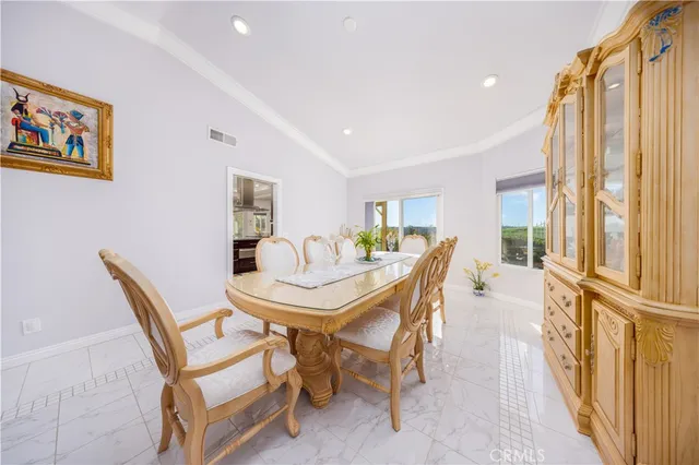a view of a dining room with furniture and a large window
