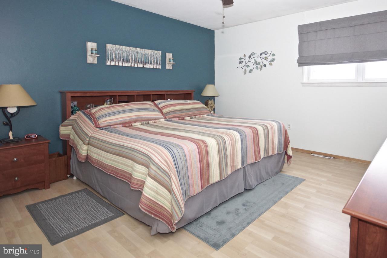 14 Constitution Road Clementon, NJ 08021 - Photo 12 of 27 a bedroom with a bed and a lamp on dresser