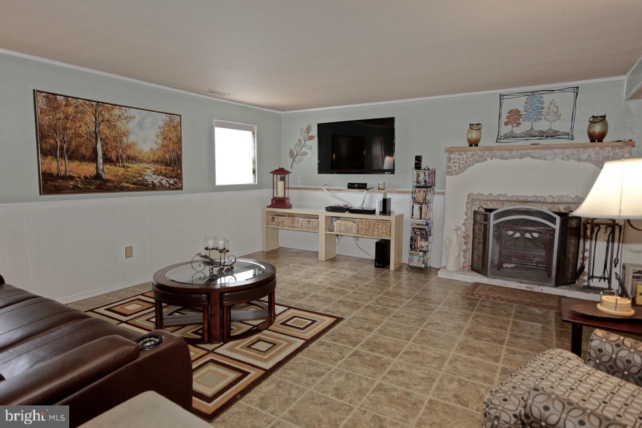 14 Constitution Road Clementon, NJ 08021 - Photo 15 of 27 a living room with furniture a flat screen tv and kitchen view