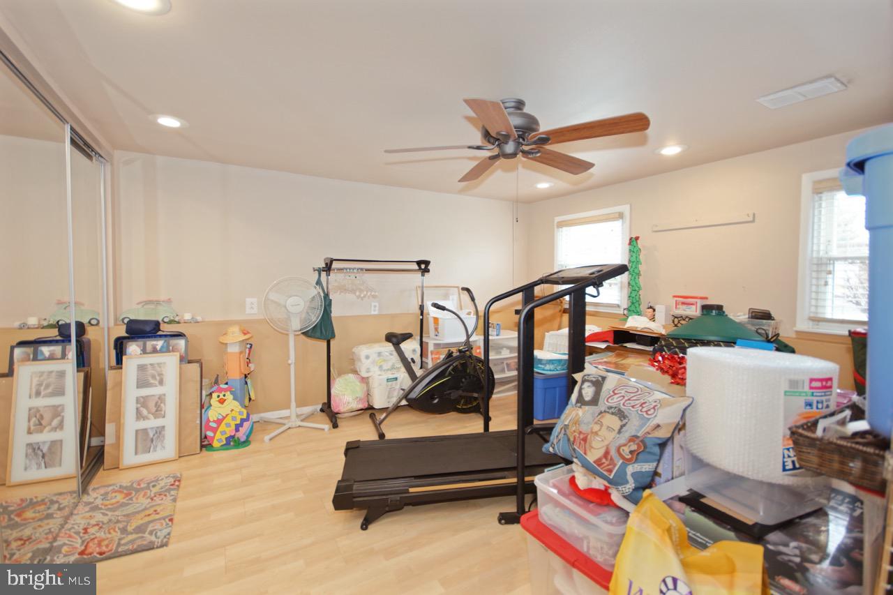 14 Constitution Road Clementon, NJ 08021 - Photo 21 of 27 a living room with lots of furniture and a gym machine