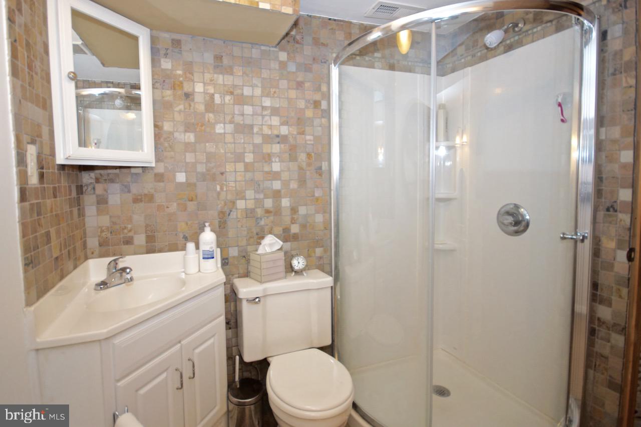 14 Constitution Road Clementon, NJ 08021 - Photo 23 of 27 a bathroom with a sink a toilet and shower