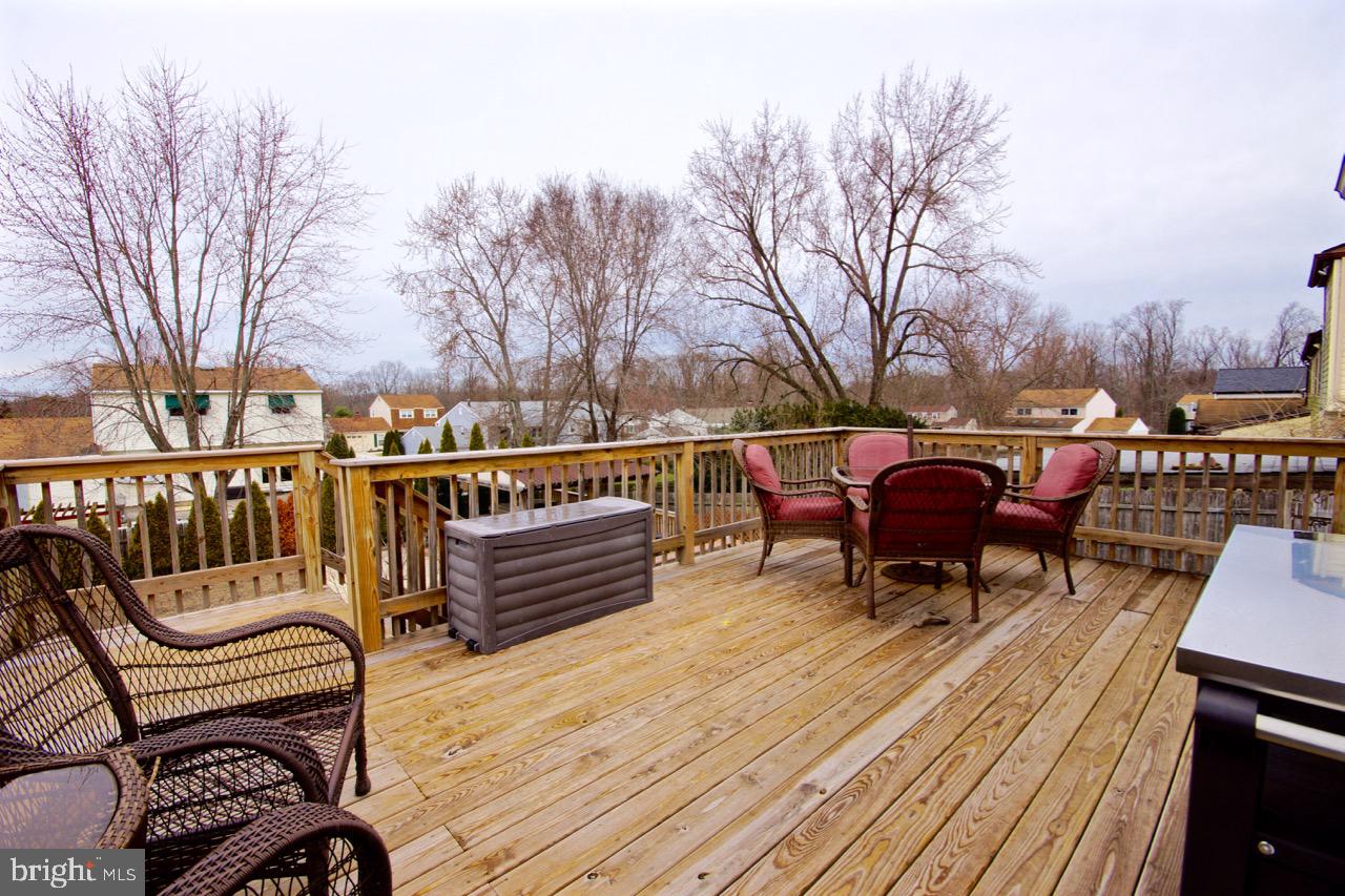 14 Constitution Road Clementon, NJ 08021 - Photo 24 of 27 a view of a roof deck with table and chairs and wooden floor