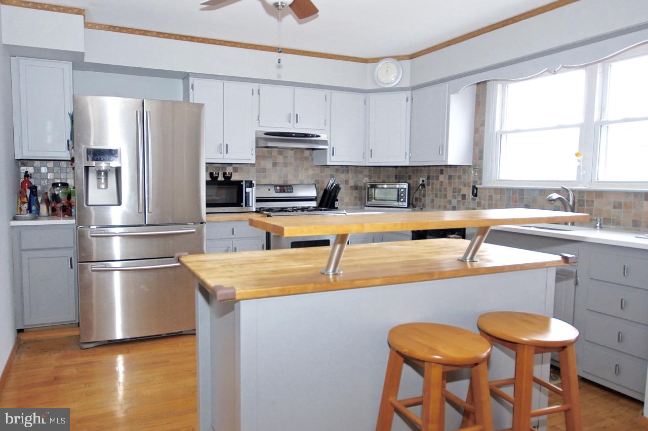 14 Constitution Road Clementon, NJ 08021 - Photo 9 of 27 a kitchen with a refrigerator a stove a sink and white cabinets