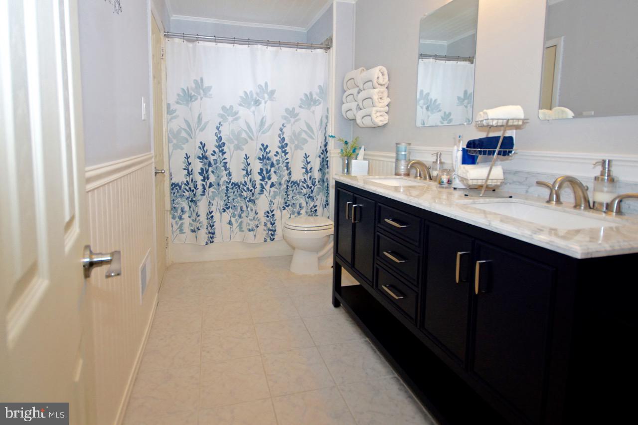 14 Constitution Road Clementon, NJ 08021 - Photo 10 of 27 a bathroom with a double vanity sink mirror and shower