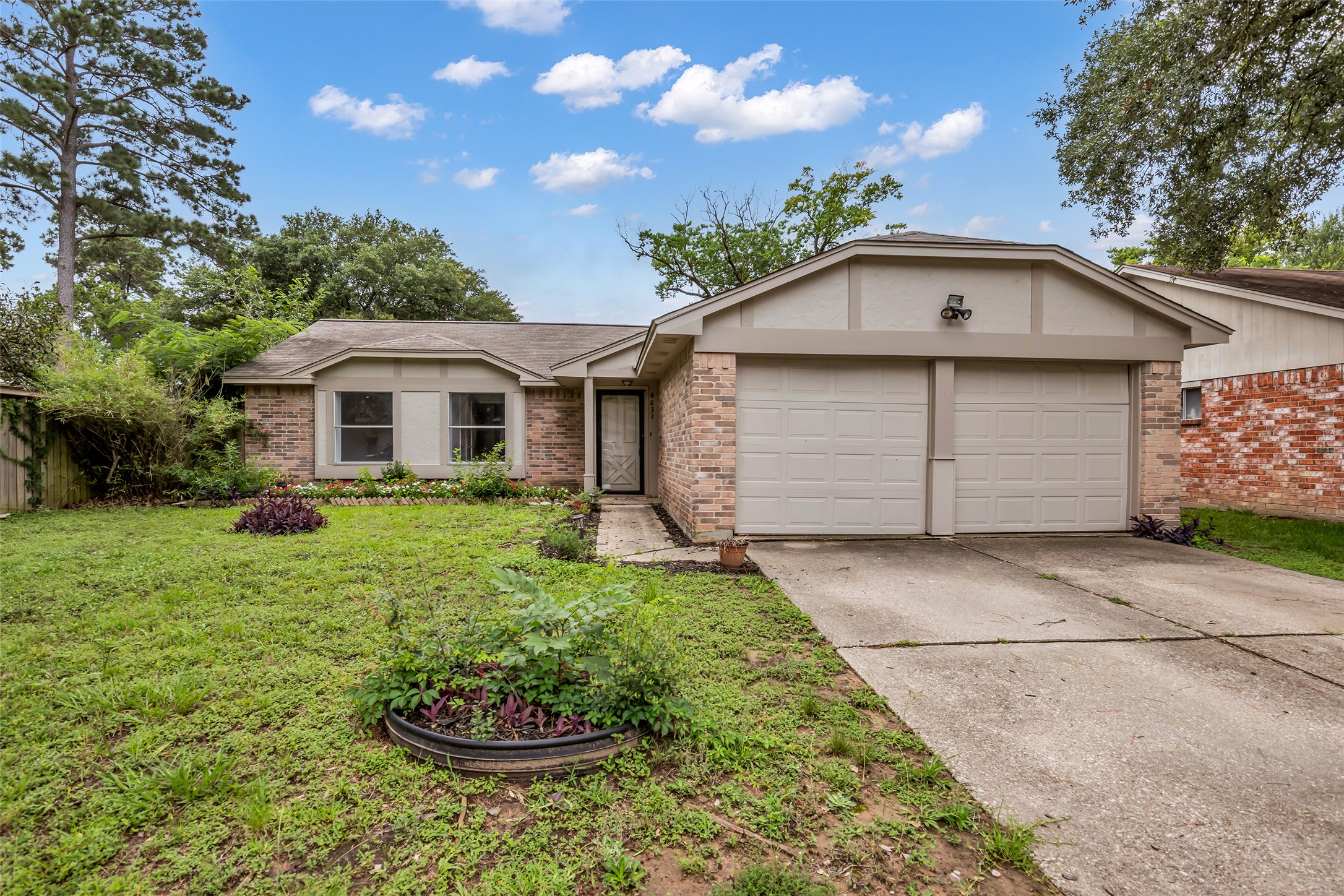 4631 Enchanted Rock Lane Spring, TX 77388 - Photo 1 of 12 A classic brick exterior offers enduring charm, complemented by a practical attached garage.
