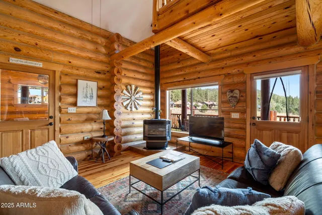a view of a balcony with wooden floor & fence