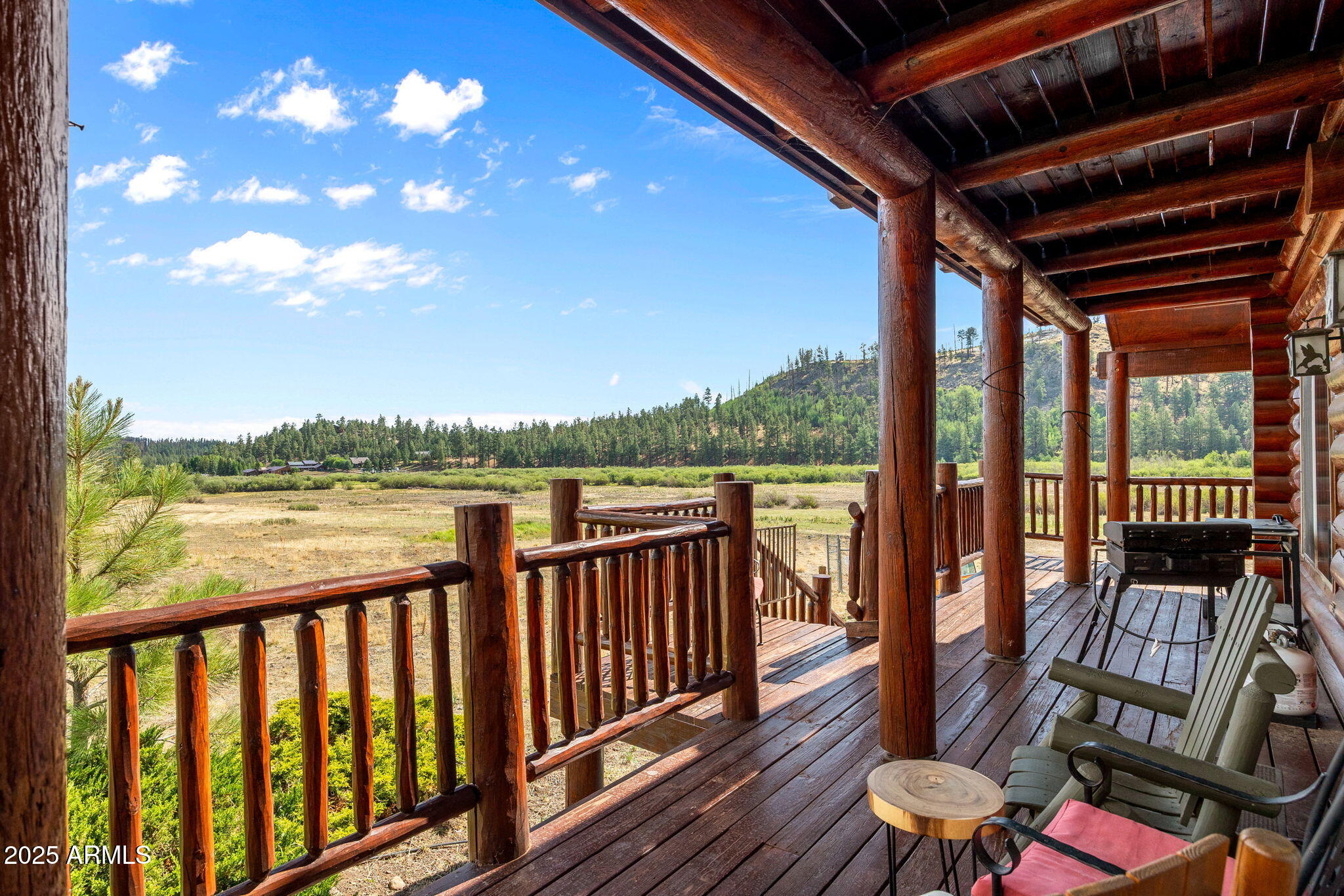 100 Main Street Greer, AZ 85925 - Photo 15 of 63 a view of a balcony with wooden floor & fence