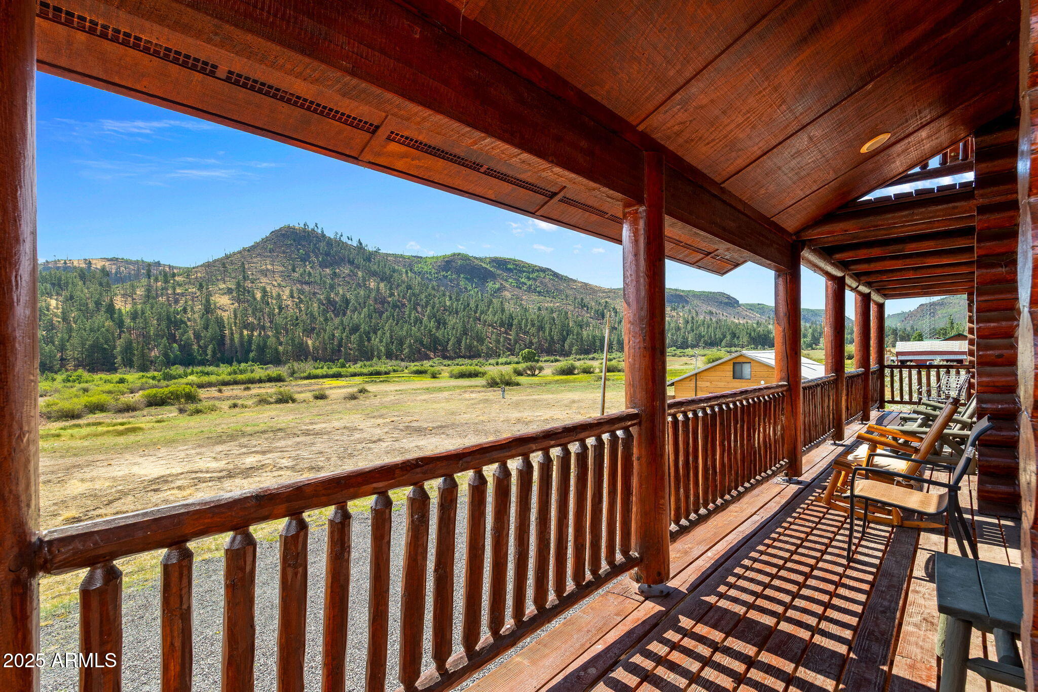 100 Main Street Greer, AZ 85925 - Photo 16 of 63 a view of balcony with wooden floor and fence