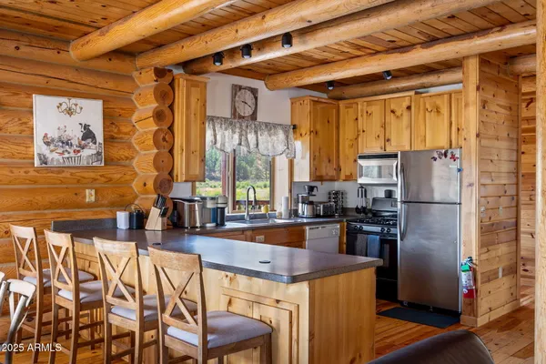 a bedroom with a bed and a dresser next to a window