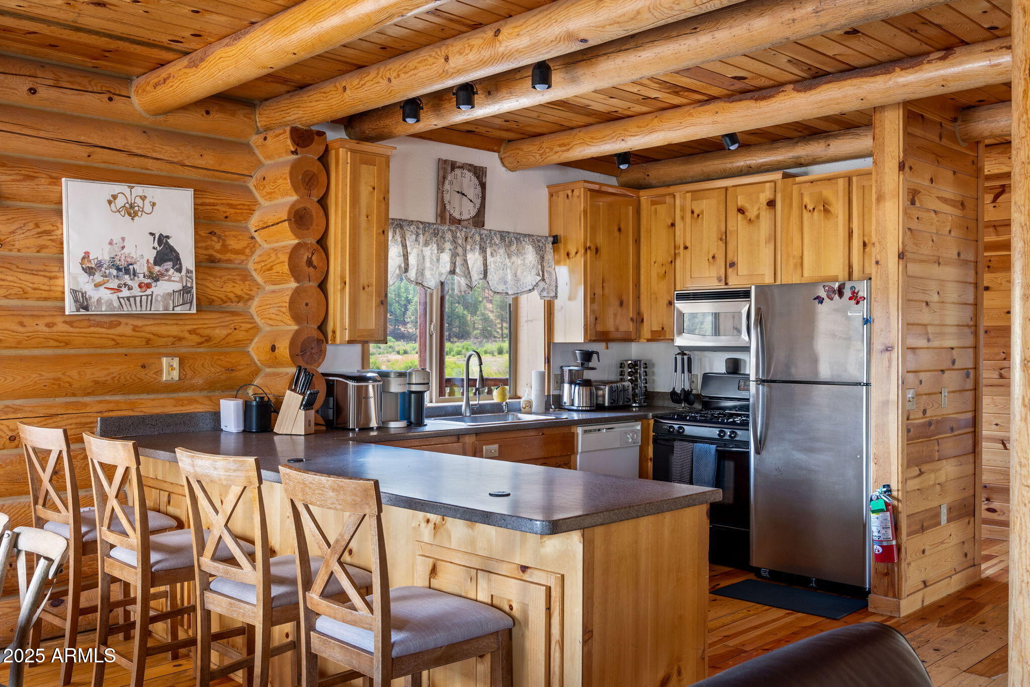 100 Main Street Greer, AZ 85925 - Photo 18 of 63 a kitchen with stainless steel appliances granite countertop a refrigerator and a stove top oven