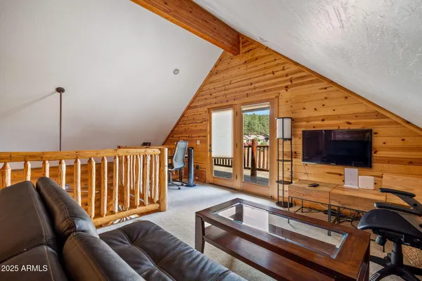 a bedroom with a bed couch and a large window