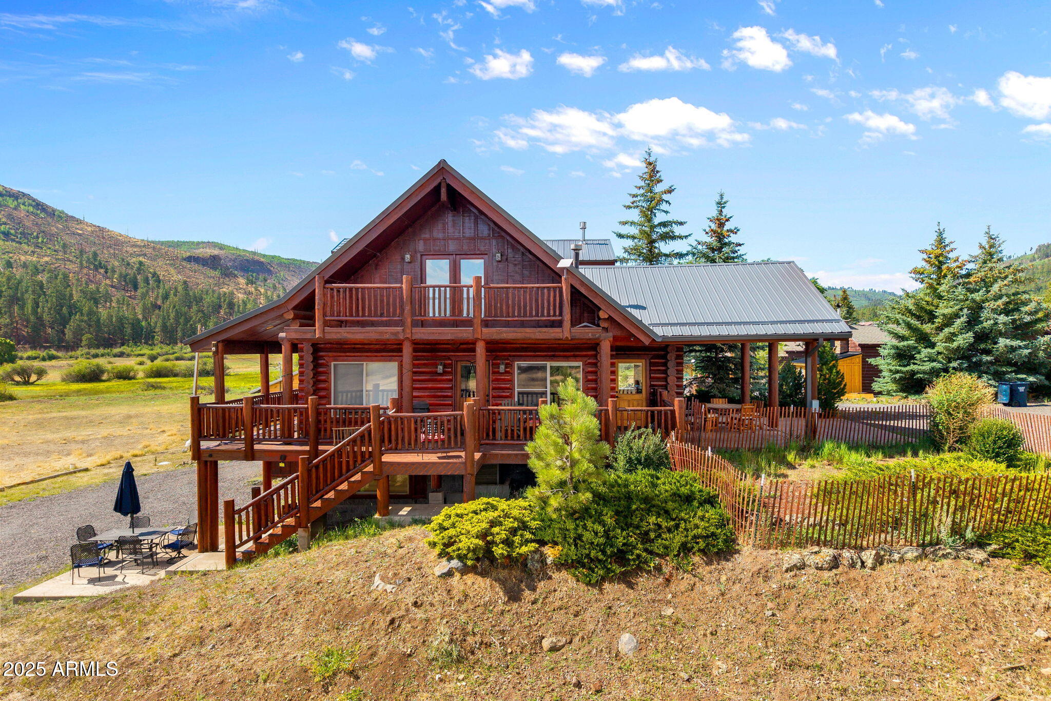 100 Main Street Greer, AZ 85925 - Photo 2 of 63 a front view of a house with garden