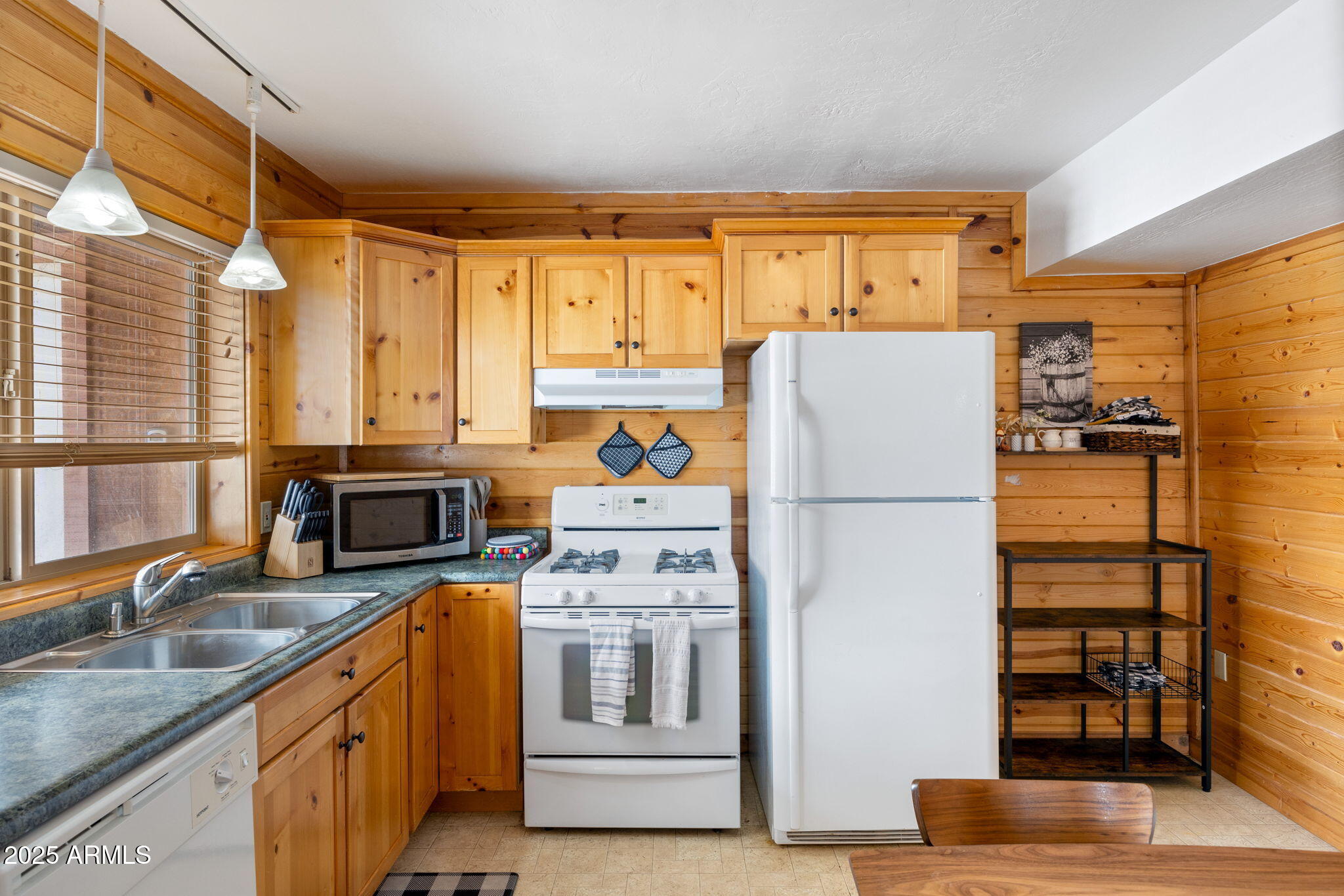 100 Main Street Greer, AZ 85925 - Photo 40 of 63 a kitchen with stainless steel appliances granite countertop a refrigerator a stove and a sink with wooden floor