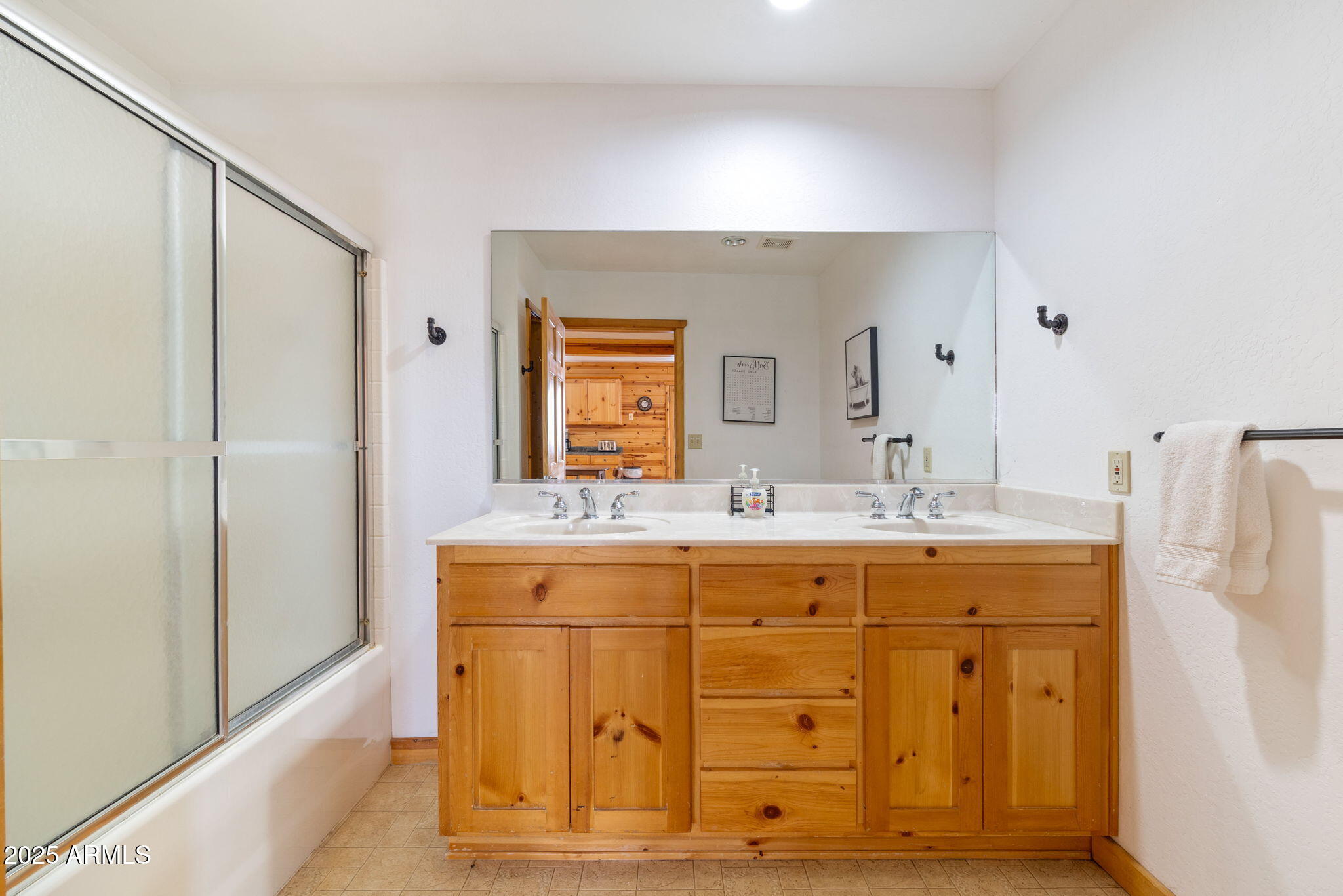 100 Main Street Greer, AZ 85925 - Photo 43 of 63 a bathroom with a double vanity sink and mirror
