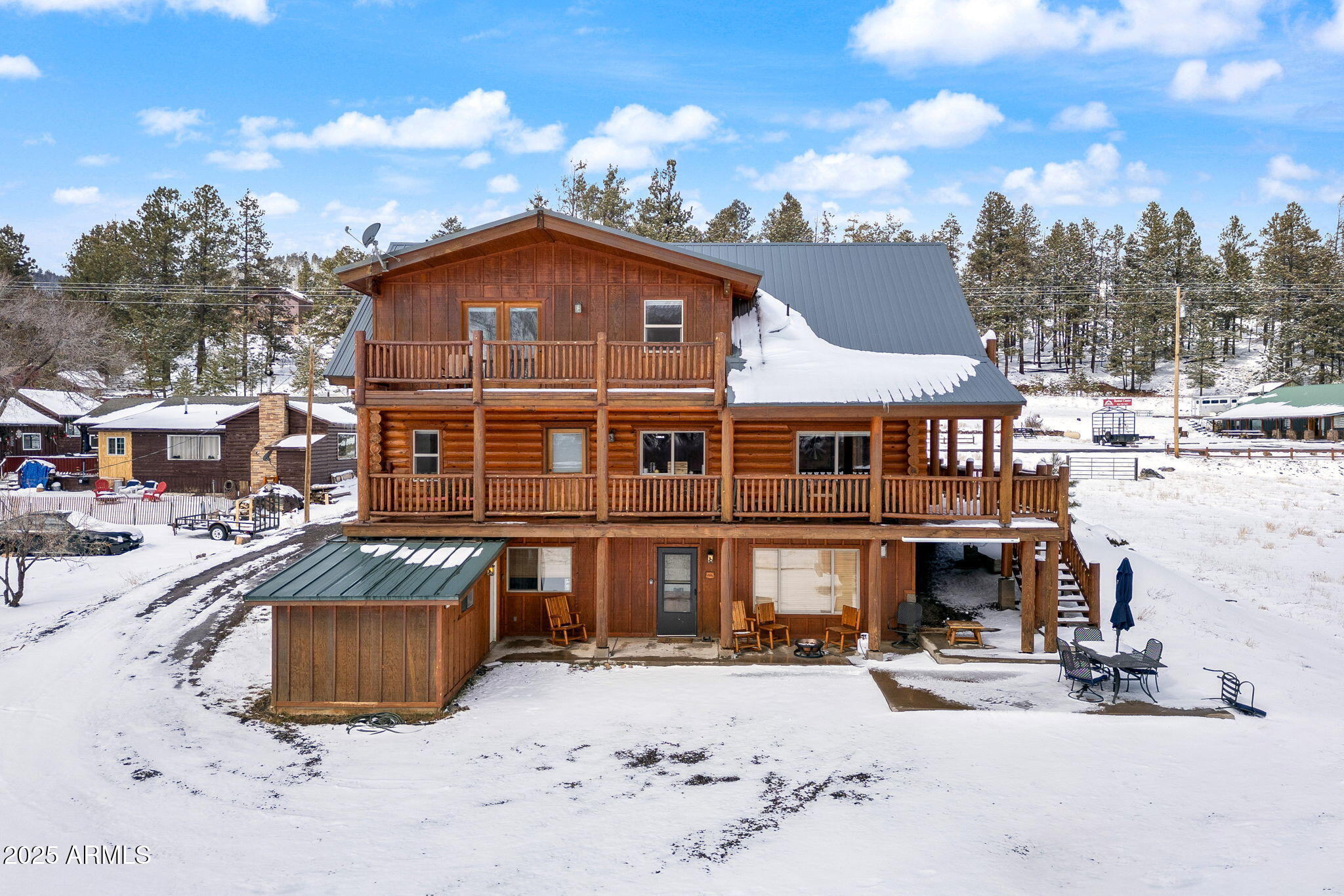 100 Main Street Greer, AZ 85925 - Photo 49 of 63 a front view of a house with a yard covered with snow