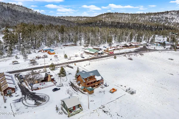 a view of a patio with a table chairs and a floor to ceiling window