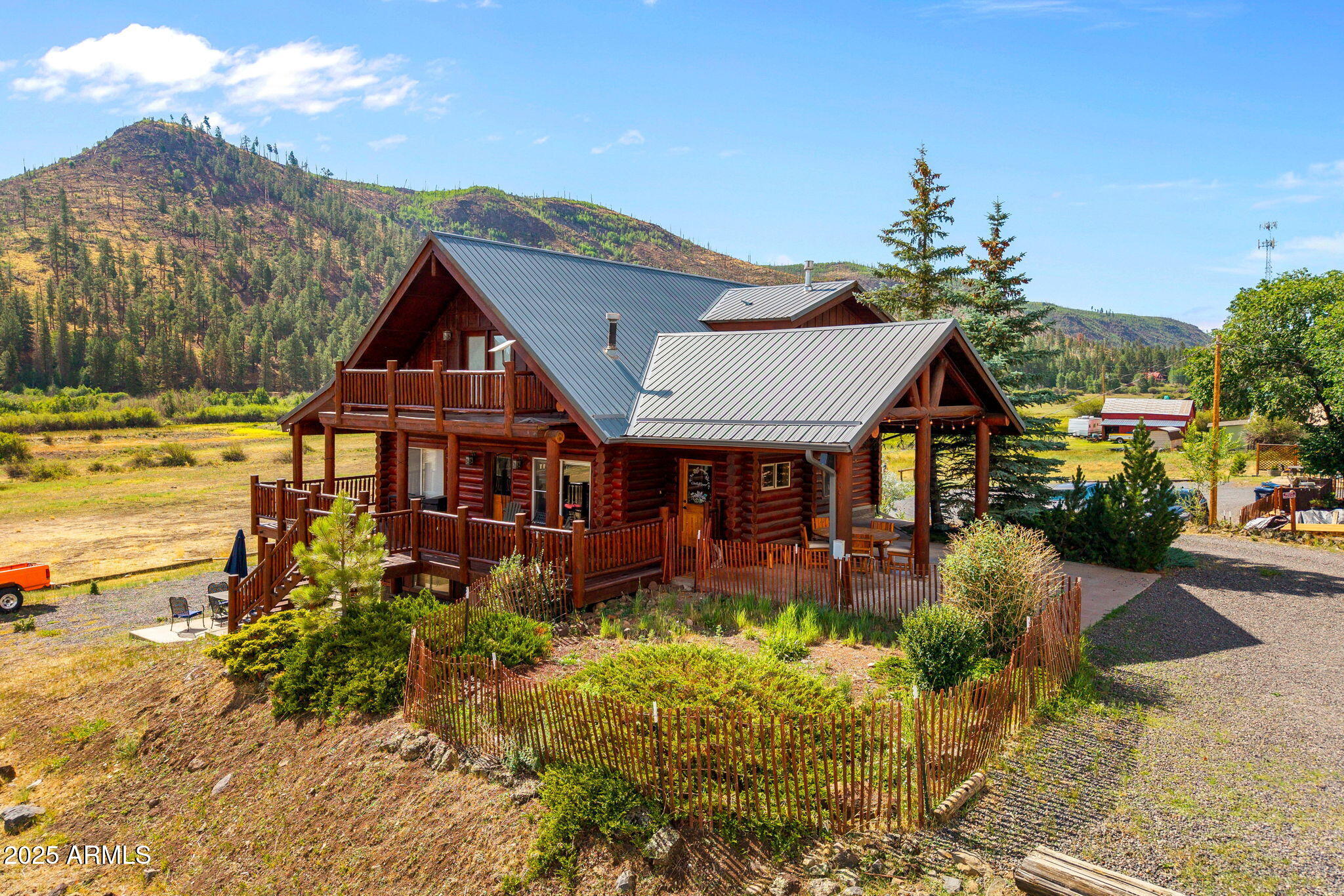 100 Main Street Greer, AZ 85925 - Photo 4 of 63 a front view of a house with a yard