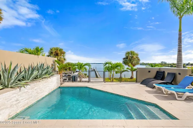 a view of a swimming pool with a table and chairs