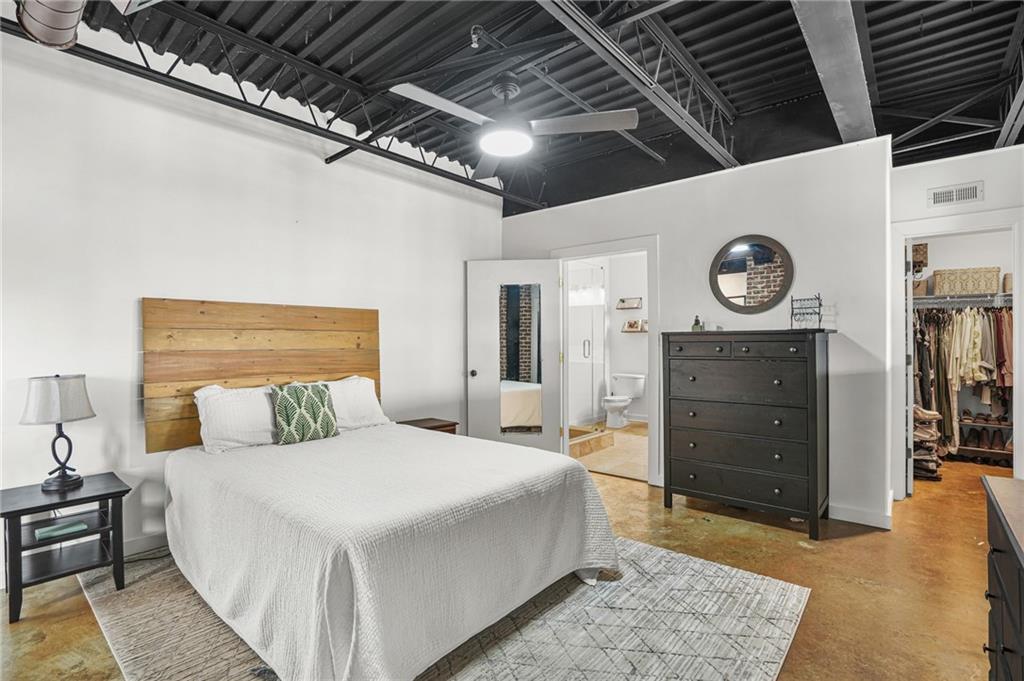 5434 Peachtree Road, Unit 119 Atlanta, GA 30341 - Photo 21 of 44 a large bedroom with a bed and a mirror