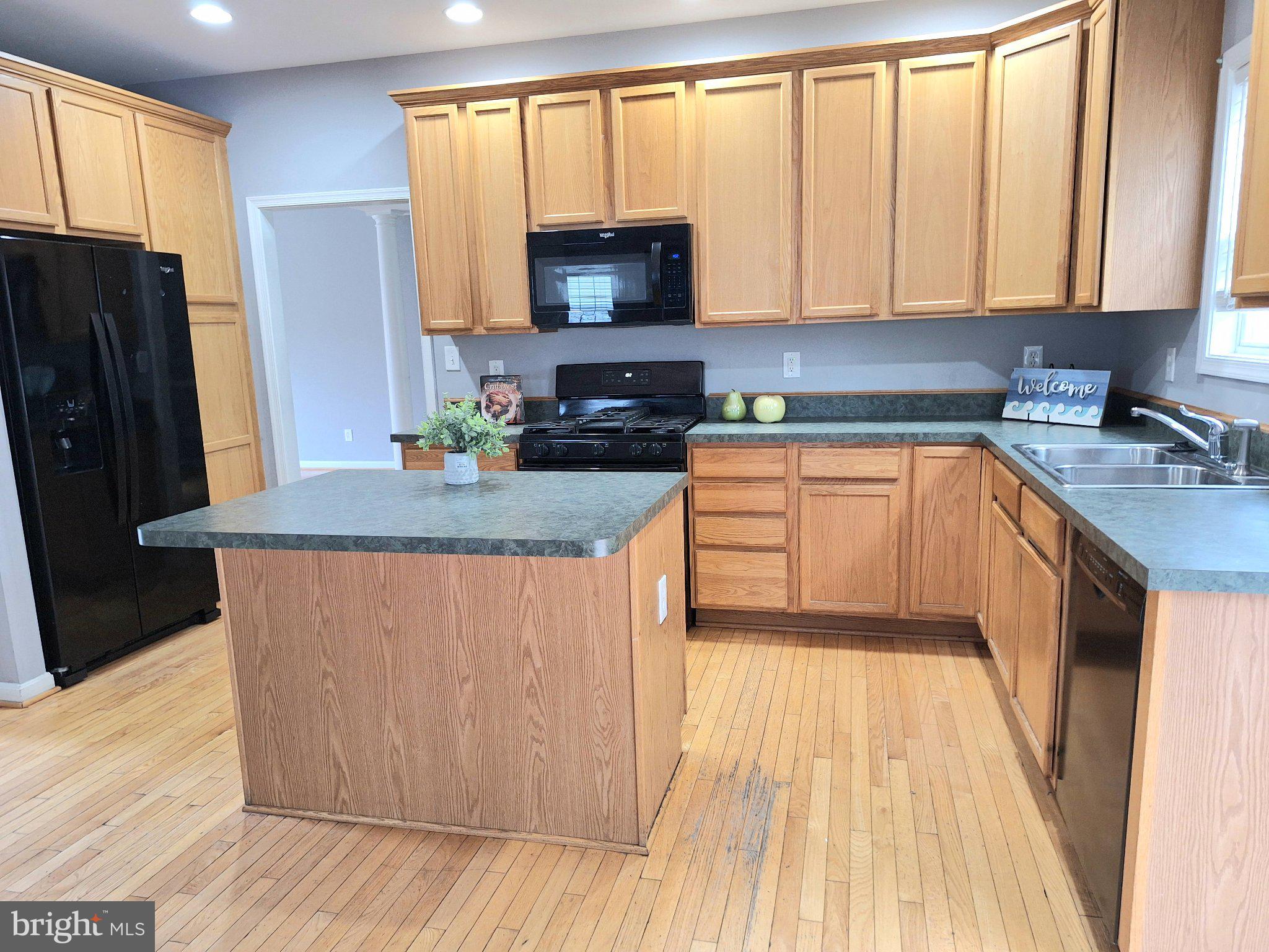 7906 Springridge Road Glen Burnie, MD 21060 - Photo 7 of 28 Spacious kitchen with warm wood tones.