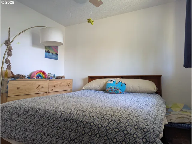 a bedroom with a bed and a dresser