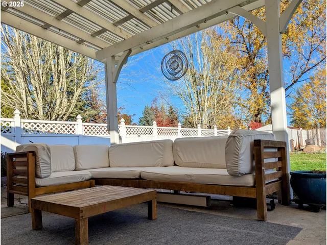 a view of a wooden house with a floor to ceiling window and a potted plant