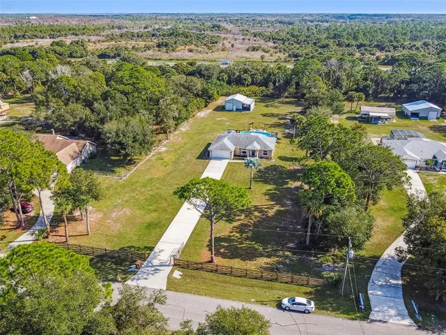 a front view of a house with yard and glass windows
