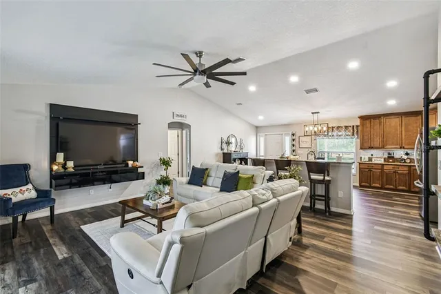 a bedroom with a large bed and a flat tv screen