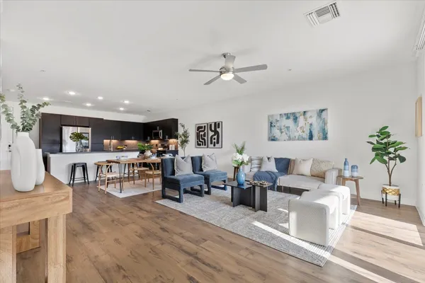 a kitchen with a sink and wooden floor