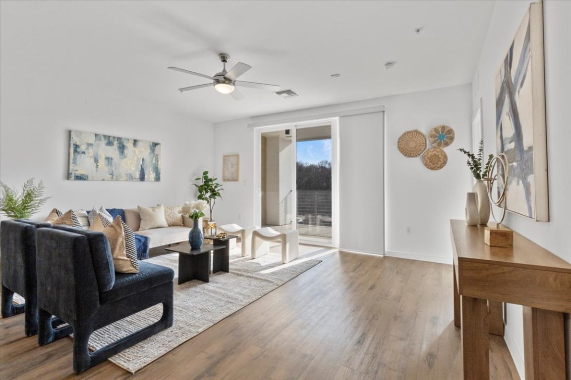 4801 Springdale Road, Unit 1107 Austin, TX 78723 - Photo 11 of 40 Living area featuring wood finished floors and a ceiling fan
