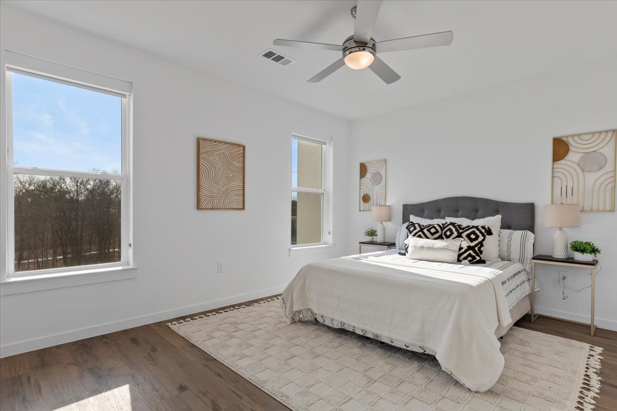 4801 Springdale Road, Unit 1107 Austin, TX 78723 - Photo 13 of 40 a bedroom with a bed and wooden floor